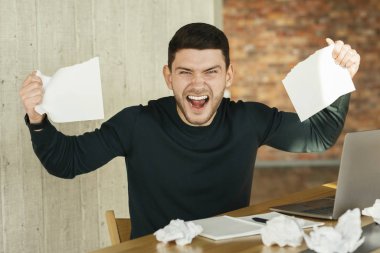 Emotional Office Worker Screaming Crumpling Paper At Workplace Indoor