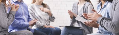 Group of unrecognizable people applauding to woman at psychotherapy session