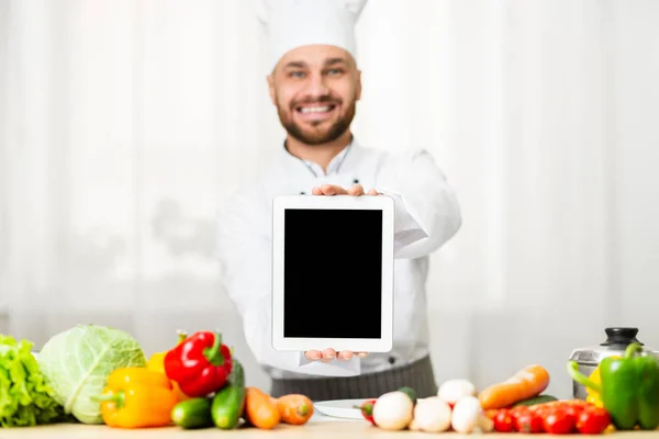 Joyful Chef Showing Digital Tablet Screen To Camera In Kitchen