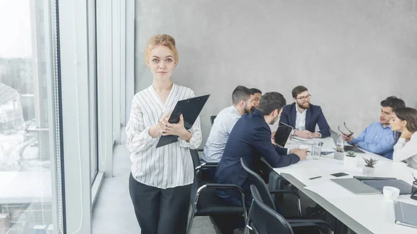 Confident female manager smiling to camera in office — Stock Photo, Image