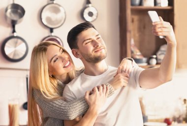 Beautiful couple making selfie using a smartphone