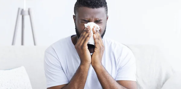 Black man suffering from snotty nose at home — Stock Photo, Image