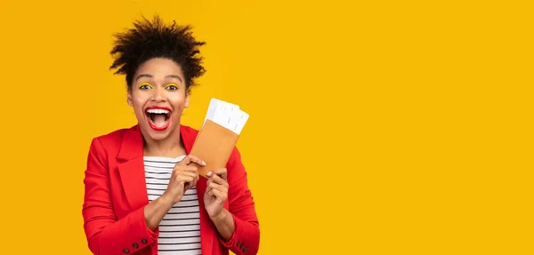 Mujer afro excitada sosteniendo boletos y pasaporte —  Fotos de Stock