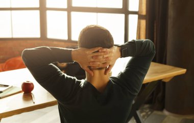 Unrecognizable Young Man Resting Sitting At Workplace Indoor