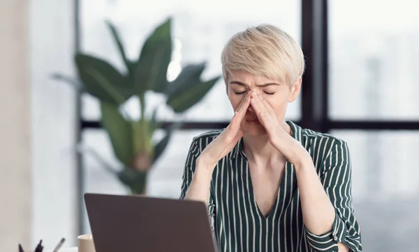 Woman Touching Nosebridge Having Sinus Pain Sitting At Workplace Indoors — 스톡 사진