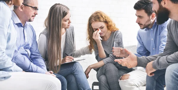 Depressed crying woman receiving empathy from Support Group members — 스톡 사진