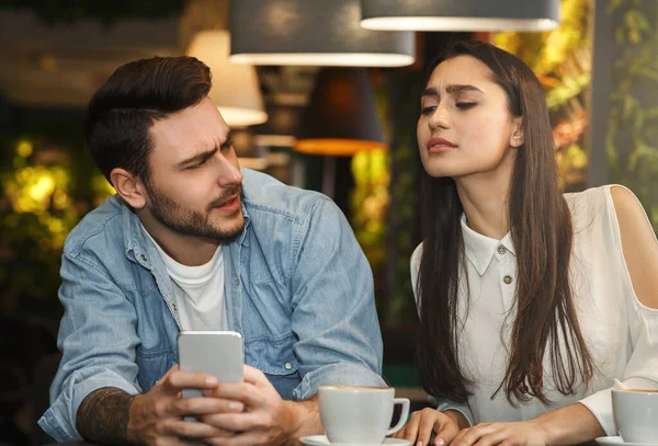 Girlfriend Reading Boyfriends Messages While He Texting Sitting In Cafe — Stock Photo, Image