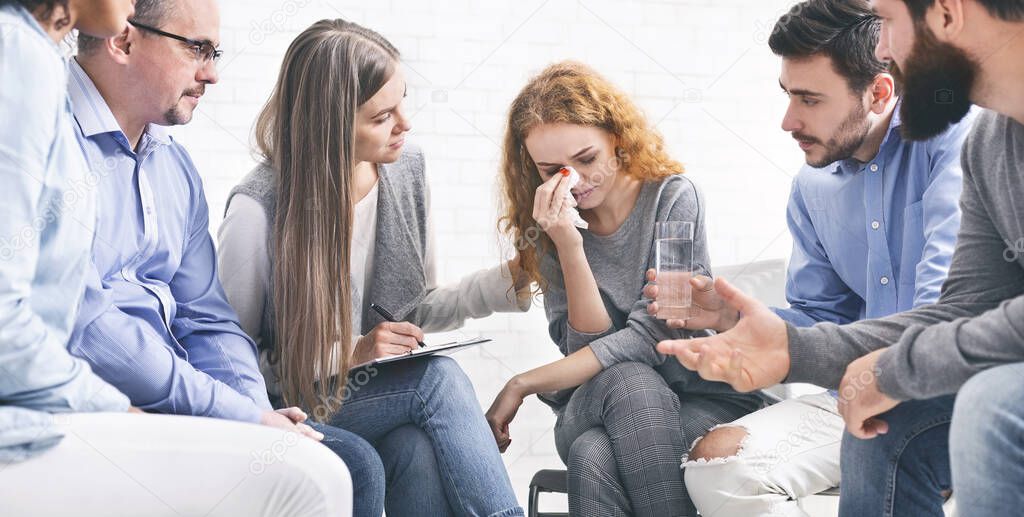 Depressed crying woman receiving empathy from Support Group members