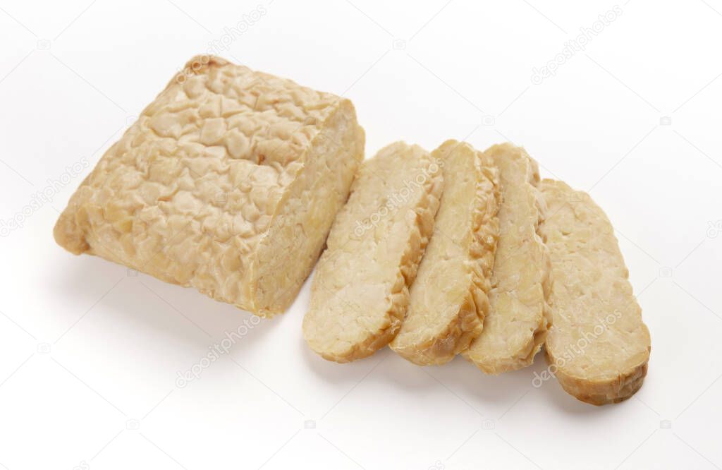 Tempeh cut into slices, isolated on white background