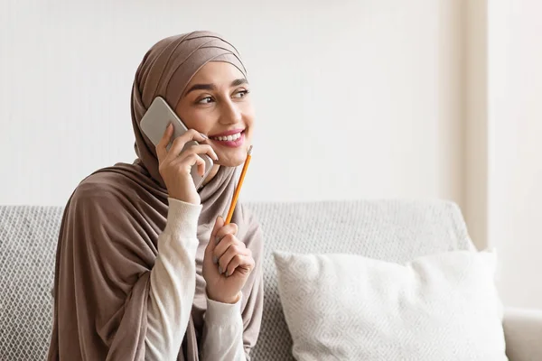 Arabic Girl Talking On Cellphone At Home with Pencil Near Face (dalam bahasa Inggris) — Stok Foto