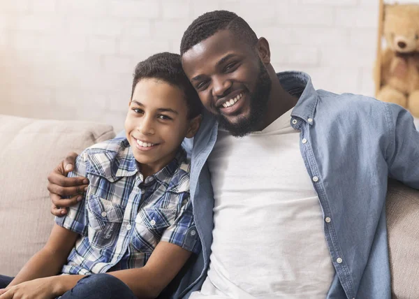 Feliz pai e filho afro-americanos levando selfie em casa — Fotografia de Stock