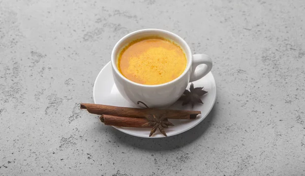 Cup of ayurvedic golden turmeric latte milk with curcuma powder — Stock Photo, Image