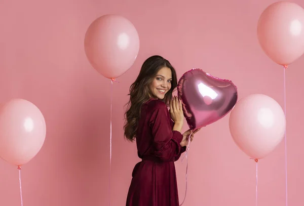 Portrait de jolie jeune fille avec des ballons à air sur fond rose — Photo