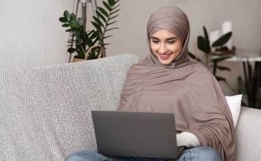 Beautiful Arab Girl Using Laptop Computer At Home, Chatting Online