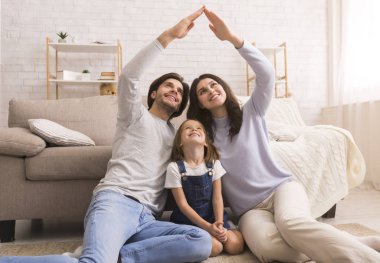 Caring parents making symbolic roof of hands above little daughters head clipart