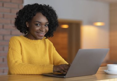 Portrait of young businesswoman using laptop at cafe