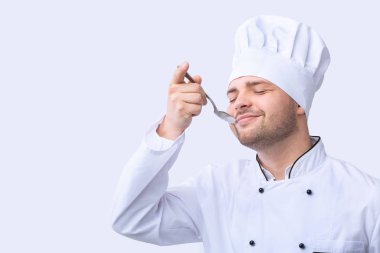Chef Tasting Food Holding Spoon Standing, Studio Shot