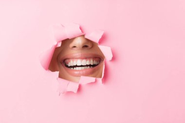 Girl Smiling Through A Hole In Pink Paper, Empty Space