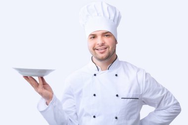 Chef Holding Empty Plate Posing In Studio On White Background