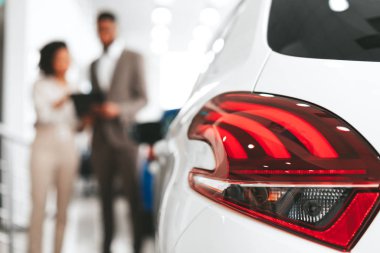 Unrecognizable Woman Signing Deal Standing Near Car In Dealership Office