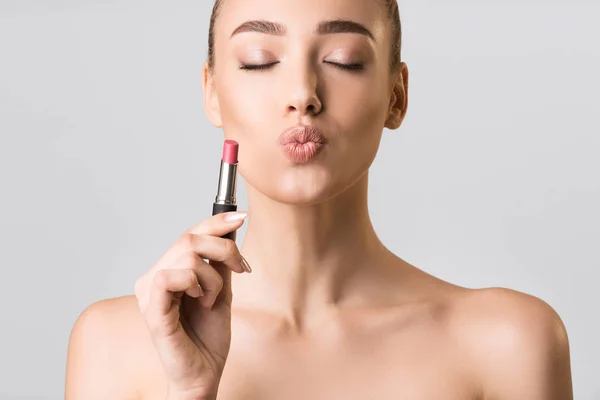 Model Girl Holding Lipstick Posing On Gray Studio Background — Stok fotoğraf
