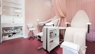 White leather armchairs for pedicure with professional tools