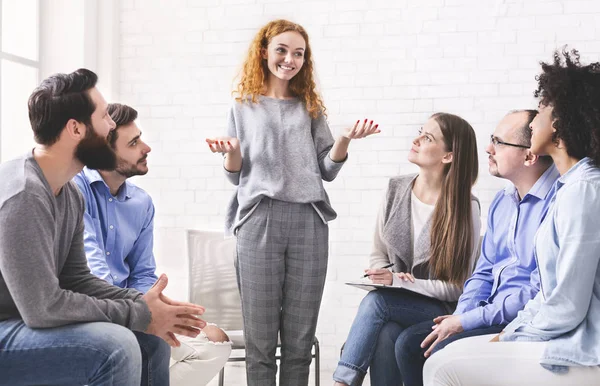 Young woman telling how she overcame drug addiction at group meeting — Stok fotoğraf