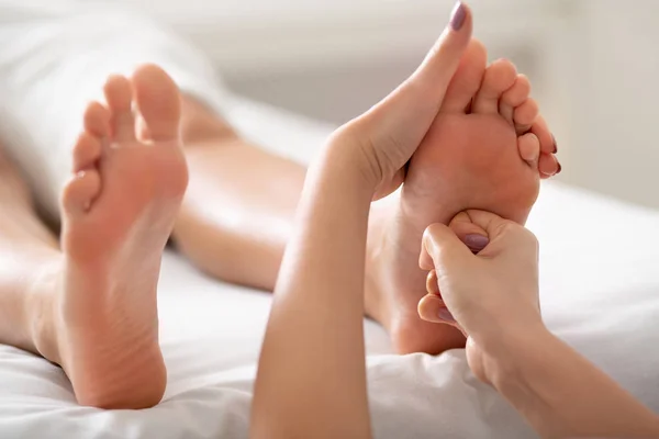 Physiotherapist pressing specific spots on female foot — 스톡 사진