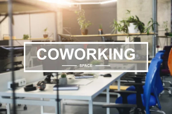 Coworking text over contemporary working space, comfortable workplace interior — 스톡 사진
