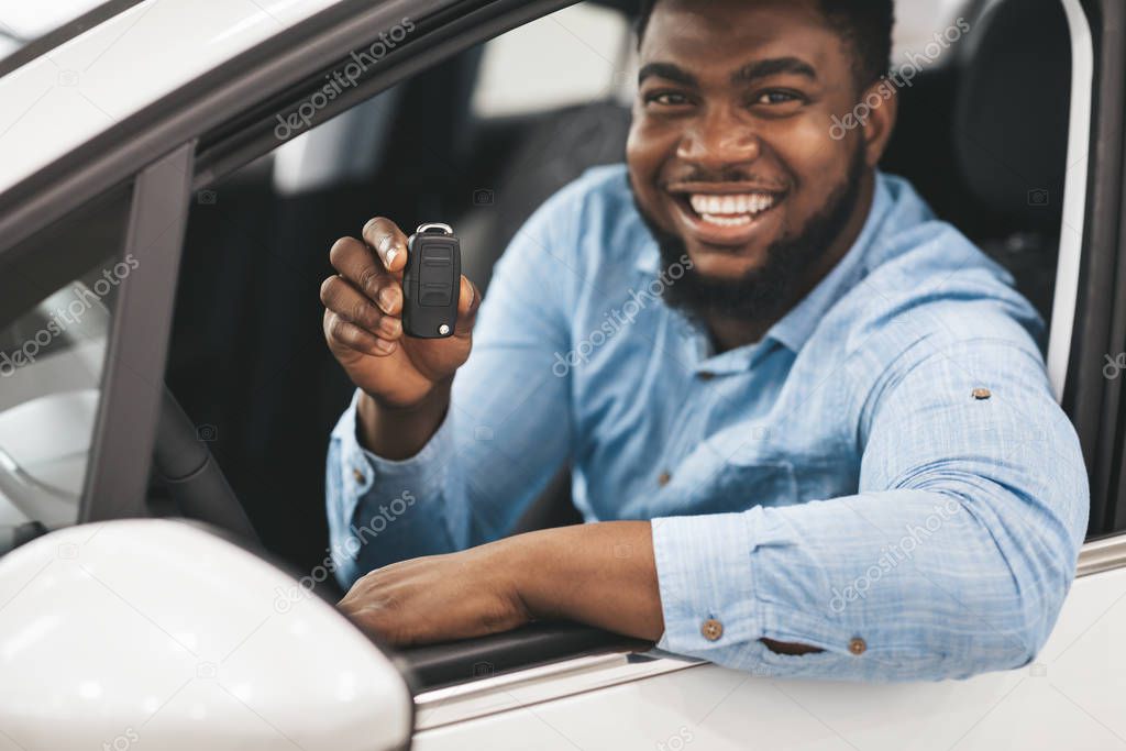 Black Guy Showing Car Key Smiling Sitting In New Automobile