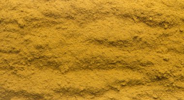 Turmeric powder texture background, copy space for text,