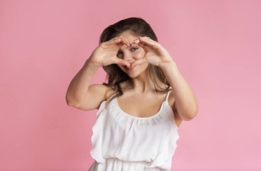 Happy Beautiful Girl Showing Heart Gesture With Fingers