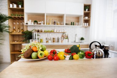 Kitchen interior. Fresh fruits and vegetables on table