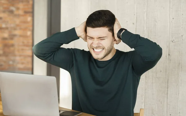 Overworked Guy Covering Ears Having Headache At Work In Office — 图库照片