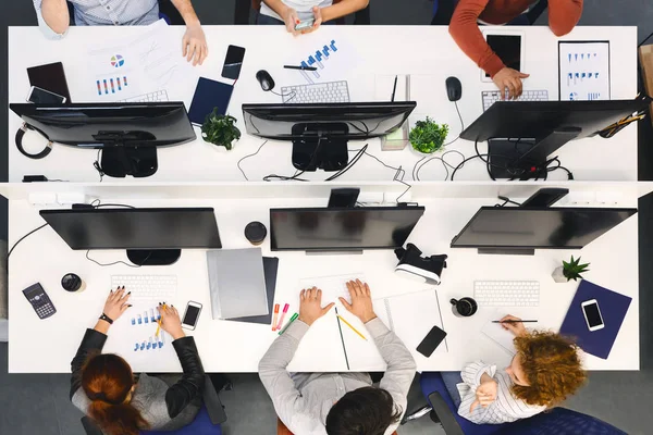 Top view of team working on computers at office — ストック写真