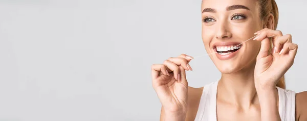 Smiling Woman Flossing Perfect Teeth Standing Over Gray Background, Panorama — 图库照片