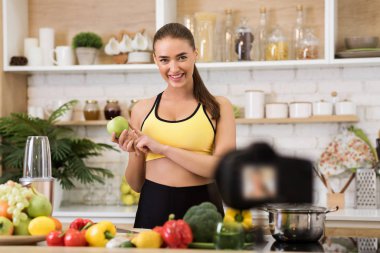 Happy girl recording blog episode about healthy food diet