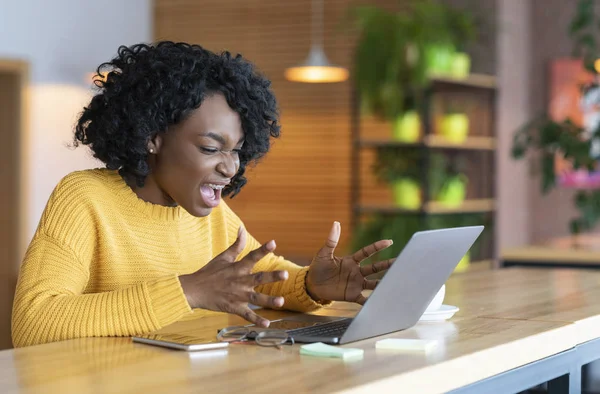 Angry black businesswoman screaming at laptop screen — Stok fotoğraf