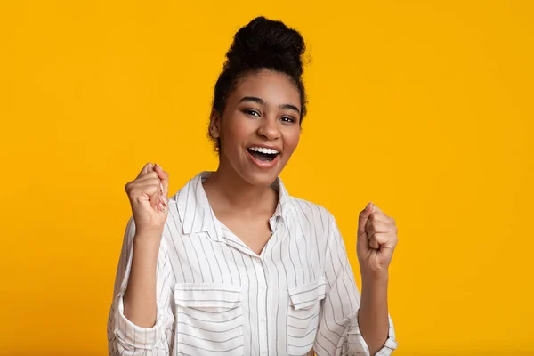 Happy Afro Girl Celebrating Victory, Shaking Fists Over Yellow Background — 图库照片