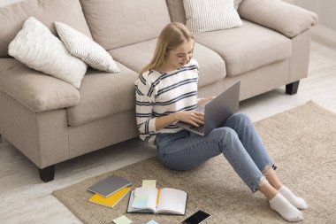 Girl Studying at Home With Laptop, sitting on floor
