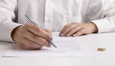 Boşanma anlaşmasını imzalayan ve boşanma kağıtlarını imzalayan bir eş.