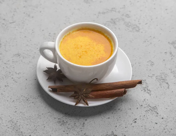 Turmeric or curcuma latte over gray table background — Stock Photo, Image