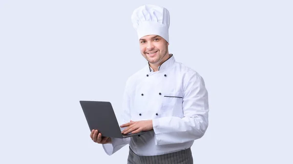 Chef Man segítségével Laptop álló fehér stúdió háttér, Panoráma — Stock Fotó