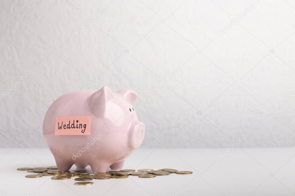 Pink piggy bank with cash money over gray background