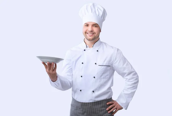 Chef hombre posando con la placa sonriendo a la cámara, Studio Shot —  Fotos de Stock