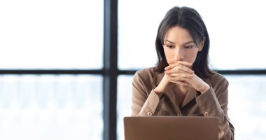 Serious european manager using personal computer at home