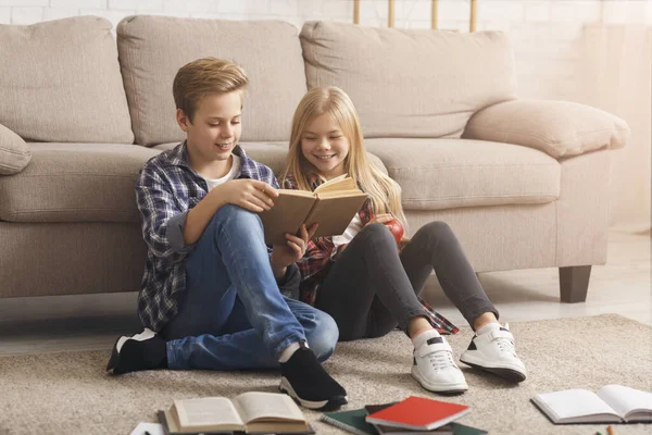 Siblings Reading Book Learning Together Sitting On Floor Indoor — Stock fotografie