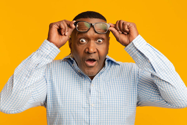 Shocked mature african american man looking at camera