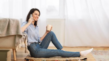Teenage Girl Talking On Phone Sitting The Floor