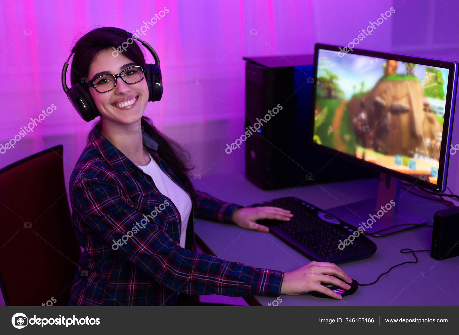 Gamer Girl At PC Smiling To Camera Sitting At Home Stock Photo by